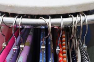 Detailed close up view on samples of cloth and fabrics in different colors found at a fabrics market photo