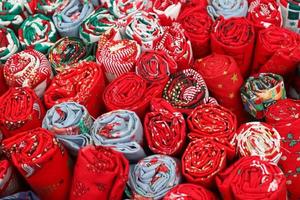 Detailed close up view on samples of cloth and fabrics in different colors found at a fabrics market photo