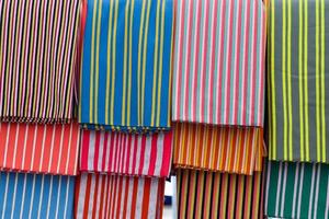 Detailed close up view on samples of cloth and fabrics in different colors found at a fabrics market photo
