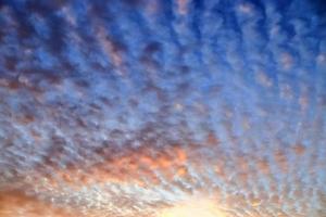 Beautiful panorama of orange and yellow clouds at sunrise photo