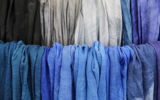 Detailed close up view on samples of cloth and fabrics in different colors found at a fabrics market photo