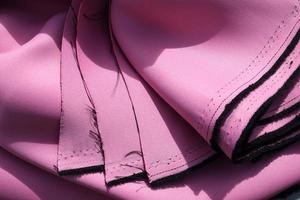 Detailed close up view on samples of cloth and fabrics in different colors found at a fabrics market photo