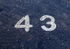 Numbers painted on concrete and asphalt surfaces photo