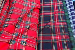 Detailed close up view on samples of cloth and fabrics in different colors found at a fabrics market photo