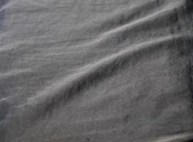 Detailed close up view on samples of cloth and fabrics in different colors found at a fabrics market photo