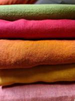 Detailed close up view on samples of cloth and fabrics in different colors found at a fabrics market photo