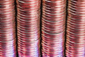 many round metal coins of silver color illuminated in red photo