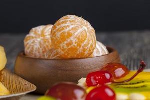 peeled ripe juicy tangerine on a wooden table photo