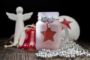 christmas candle in a glass jar and other decorations photo