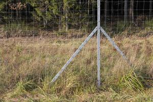 metal fences near the forest, which protect animals from the carriageway photo