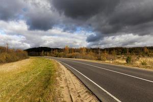 an asphalt road in the autumn season photo