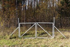 metal fences near the forest, which protect animals from the carriageway photo