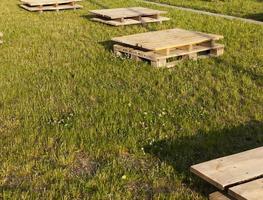 wooden pallets on the grass, close up photo