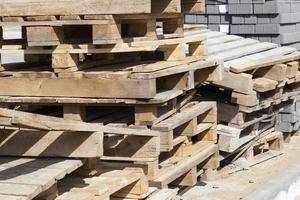 empty wooden pallets and new construction tiles photo