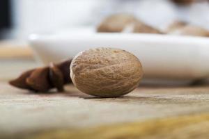 nutmeg scattered on an old wooden table photo