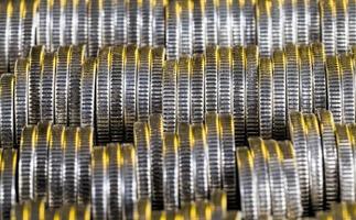 many round metal coins of silver color illuminated with Golden color photo