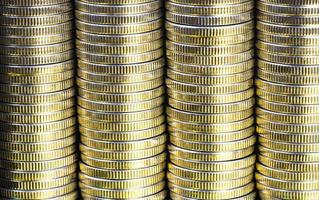 many round metal coins of silver color illuminated in yellow photo