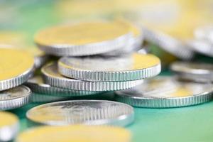 metal coins stacked together on a green background photo