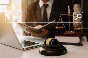 Searching Browsing Internet Data Information Networking Concept with blank search bar.justice and law concept.Male judge in a courtroom with the gavel,working with digital tablet computer. photo