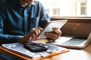 business documents on office table with smart phone and digital tablet and graph financial photo