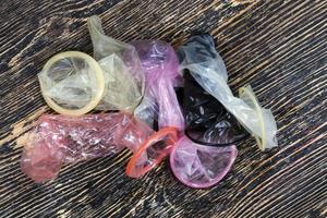 a group of quality latex condoms of different colors photo