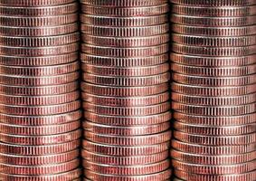 many round metal coins of silver color illuminated in red photo