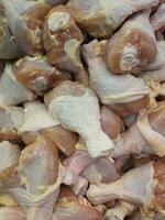 Close-up of raw chicken drumsticks with skin which were sold in supermarket. photo