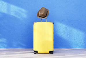 Black color luggage or baggage bag on blue background for transportation travel photo