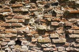 crumbling old brick wall photo