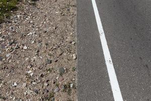 asphalt road with white road markings photo