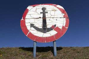 round sign with a red color photo