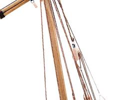 photographed close-up of a model sailing ship, made by hand from the tree, a small depth of field , on a light background photo