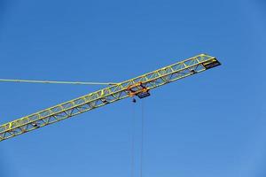 tall yellow construction crane photo