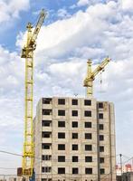 construction cranes with construction equipment photo
