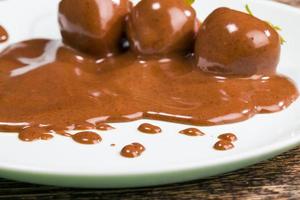 chocolate covered red berries of ripe strawberries photo