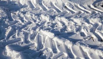 Traces of the car on the snow photo