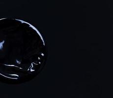 new black condom on a black background photo