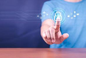 Cybersecurity and privacy concepts to protect data. Lock icon and internet network security technology. Businessman protecting personal data on smart phone with virtual screen interfaces. photo