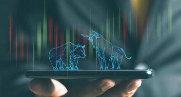 bull and bear shape writing by lines and dots over the Stock market chart with information over the Modern business building glass of skyscrapers, trading and finance investment concept photo