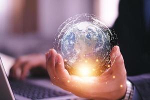 Businessman holding in hands with global connection concept. Energy saving concept, Elements of this image furnished by NASA photo