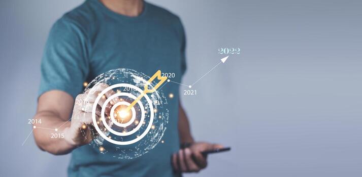 Man holding red arrow dart to virtual target dart board. Setup objectives and target for business investment concept, Digital marketing, Business goal and technology concept. photo