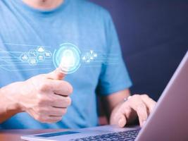 Cybersecurity and privacy concepts to protect data. Lock icon and internet network security technology. Businessman protecting personal data on smart phone with virtual screen interfaces. photo
