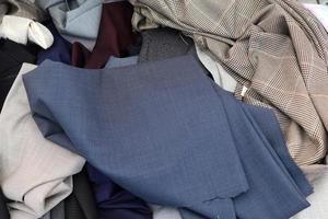 Detailed close up view on samples of cloth and fabrics in different colors found at a fabrics market photo