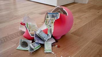 Smashing a piggy bank with a hammer, stock footage video by Brian Holm Nielsen