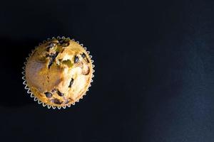 wheat cupcake with chocolate chunks, close up photo