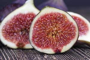 ripe purple figs on a wooden table photo
