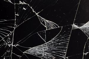 broken thin glass with lots of cracks photo