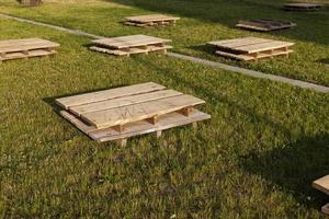 wooden pallets on the grass, close up photo