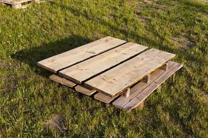 wooden pallets on the grass, close up photo