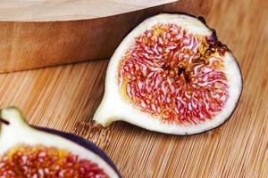 ripe purple figs on a wooden table photo